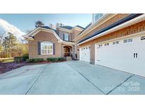 Charming brick home featuring an attached three-car garage and arched entryway at 407 Blue Bay Ct, York, SC 29745