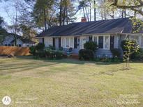 Charming ranch home with a spacious yard and mature trees at 515 N Pine Ln, Wadesboro, NC 28170