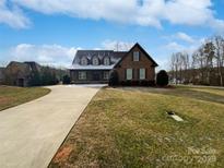 Brick house with a large front yard and driveway at 6000 Bickett Ridge Dr, Monroe, NC 28110