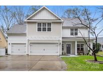 Two-story house with neutral siding, white trim, and a two-car garage at 6030 Sharon Hills Rd, Charlotte, NC 28210