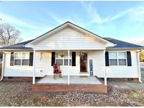 Charming one-story home with front porch and rocking chair at 1105 Mount Olivet Rd, Kannapolis, NC 28083