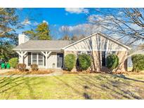 Brick ranch home with landscaped yard and covered porch at 11816 Park Rd, Charlotte, NC 28226