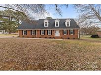 Brick ranch house with a large front yard and mature trees at 1212 Ridge St, Albemarle, NC 28001