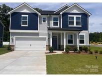 Charming two-story home with a two car garage, manicured lawn, and a blue and gray color scheme at 12131 Plummer Ct # 1, Midland, NC 28107