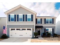 Two-story house with gray siding, white garage door, and dark shutters at 131 Crownpiece St, Troutman, NC 28166