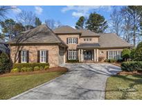 Brick home with a large driveway and landscaping at 15409 Brem Ln, Charlotte, NC 28277