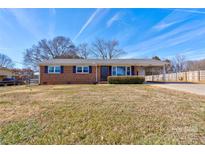 Brick ranch house with carport and landscaped yard at 1691 Montevista Dr, Shelby, NC 28150