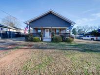 Charming gray house with front porch and well-maintained lawn at 17 Walnut St, China Grove, NC 28023