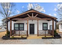 Charming white house with a modern farmhouse style and a welcoming front porch at 19601 S Ferry St, Cornelius, NC 28031