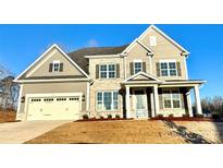 Two-story house with stone accents and a three-car garage at 2558 Red Hill Nw St # 51, Concord, NC 28027