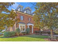 Brick home with a three-story design, dormers, and landscaping at 303 Hillside Ave, Charlotte, NC 28209