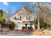 Two-story house with beige siding, green door, and attached garage at 4210 Saguaro Ct, Charlotte, NC 28269