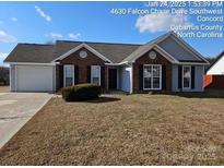 Brick and gray sided ranch home with mature landscaping at 4630 Sw Falcon Chase Sw Dr, Concord, NC 28027