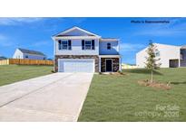 Two-story house with attached garage and grassy yard at 553 Zermatt Ct, Monroe, NC 28112