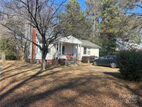 Ranch home with carport and mature trees at 1004 Druid Cir, Charlotte, NC 28206