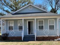 Charming light blue house with a front porch and well-maintained lawn at 1004 Johnson St, Charlotte, NC 28206