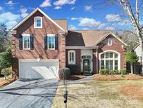 Charming brick home with a well-manicured front yard and attached two car garage at 10433 Pullengreen Dr, Charlotte, NC 28277