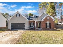 Charming home with a brick facade, well-maintained lawn, and a two-car garage at 12527 Cedar Post Ln, Charlotte, NC 28215