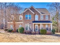 Brick two-story house with a metal roof and landscaped lawn at 209 Squirrel Ln, Lake Wylie, SC 29710