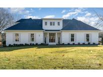 Stunning white brick home with a charming front porch and manicured lawn at 3935 Black Sycamore Dr, Charlotte, NC 28226