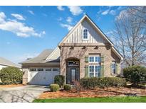 Brick home with a two-car garage and landscaped front yard at 4855 Star Hill Ln, Charlotte, NC 28214