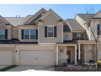 Charming townhome with two-car garage, neutral brick, and stylish gray trim, offering a welcoming curb appeal at 6007 Cadence Ln, Indian Land, SC 29707