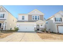 Two-story house with a white garage door and stone accents at 6525 Gopher Rd, Indian Land, SC 29707