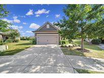 Gray Craftsman style home with attached garage and manicured landscaping at 730 Bushel Dr, Fort Mill, SC 29715