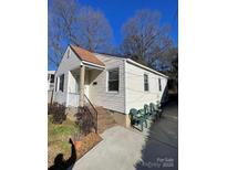Charming one-story home with a well-maintained yard, sidewalk, and neutral siding under a clear blue sky at 1217 Spruce St, Charlotte, NC 28203