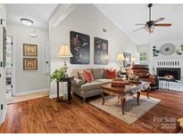 Living room with hardwood floors and a view into the hallway at 2717 New Hamlin Way, Charlotte, NC 28210