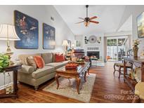 Open living area with hardwood floors, comfortable seating and fireplace at 2717 New Hamlin Way, Charlotte, NC 28210