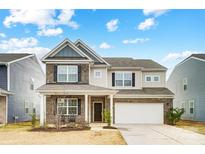 Two-story brick home with attached garage and landscaping at 3594 Cerelia Ln, Denver, NC 28037