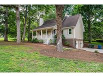 House with a garage and driveway, surrounded by trees at 5138 Foley Dr, Hickory, NC 28601