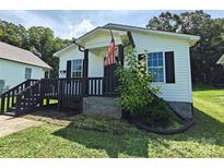 Charming home featuring a cozy front porch with black trim and an American flag at 629 S Caldwell St, Salisbury, NC 28144
