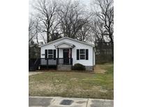 Charming home featuring a welcoming front porch, black shutters, and fresh white siding at 629 S Caldwell St, Salisbury, NC 28144