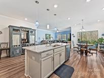 Bright, open kitchen with granite counters, stainless appliances, and seamless flow to living and dining areas at 7522 Porrera St, Charlotte, NC 28214