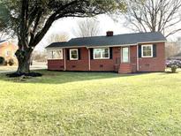 Brick ranch house with a large front yard and mature trees at 801 Broad St, Shelby, NC 28152