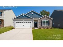 Charming single-story home featuring a stone facade, a two-car garage, and a well-manicured lawn at 1381 6Th Ne St, Hickory, NC 28601