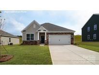 Charming single-story home featuring a two-car garage, stone accents, and a well-manicured lawn at 1400 6Th Ne St, Hickory, NC 28601
