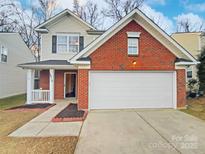 Brick front two-story house with attached garage and landscaping at 4910 Muskogee Dr, Charlotte, NC 28212