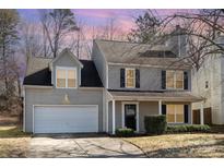 Charming two-story home featuring a two-car garage and covered front porch at 5326 Kiev Dr, Charlotte, NC 28216