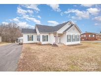 Ranch style home with a gray roof and green shutters at 6328 W Nc 10 Hwy, Hickory, NC 28602