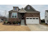 Two-story home with stone and siding exterior, attached garage, and landscaping at 1605 Appledale Ct # 116, Fort Mill, SC 29715