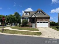 Charming home featuring stone accents, two-car garage, and a well-manicured lawn at 1605 Appledale Ct # 116, Fort Mill, SC 29715