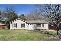 Charming one-story home featuring a well-maintained lawn, brick exterior, and classic black shutters at 1721 Edgewater Dr, Charlotte, NC 28210