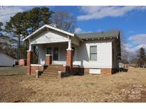 White sided home with brick base and covered porch at 1724 Lowder St, Albemarle, NC 28001