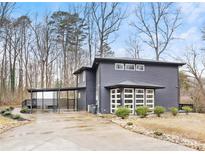 Modern two-story home with gray siding, attached carport and landscaping at 7117 W Sugar Creek Rd, Charlotte, NC 28269