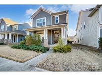 Gray two-story home with brick accents and landscaped front yard at 13328 Caite Ridge Rd, Davidson, NC 28036