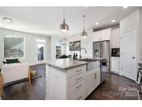 Modern kitchen features stainless steel appliances and a large island at 1428 Winding Stream Rd, Charlotte, NC 28206