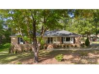 Brick ranch home with mature landscaping and walkway at 1935 Berkshire Dr, Gastonia, NC 28052